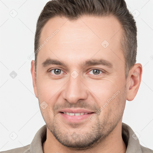 Joyful white adult male with short  brown hair and brown eyes