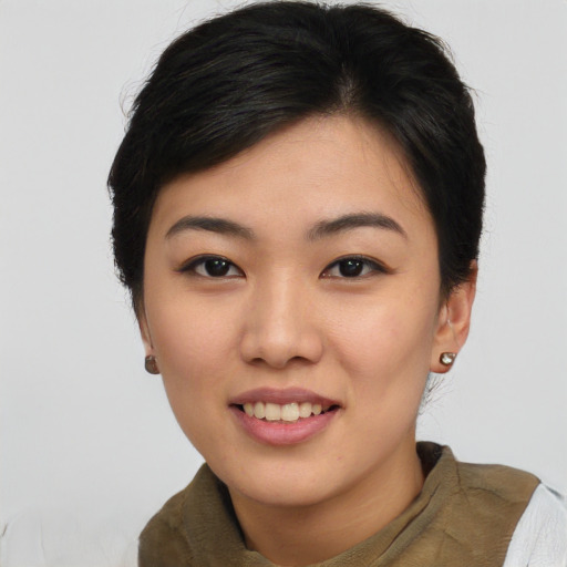 Joyful asian young-adult female with short  black hair and brown eyes
