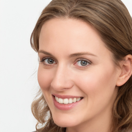 Joyful white young-adult female with long  brown hair and blue eyes