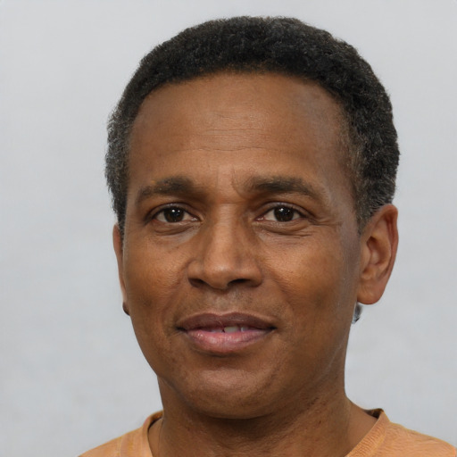 Joyful latino adult male with short  brown hair and brown eyes