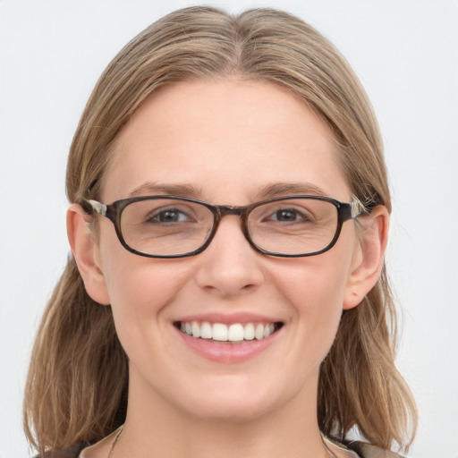 Joyful white young-adult female with medium  brown hair and blue eyes