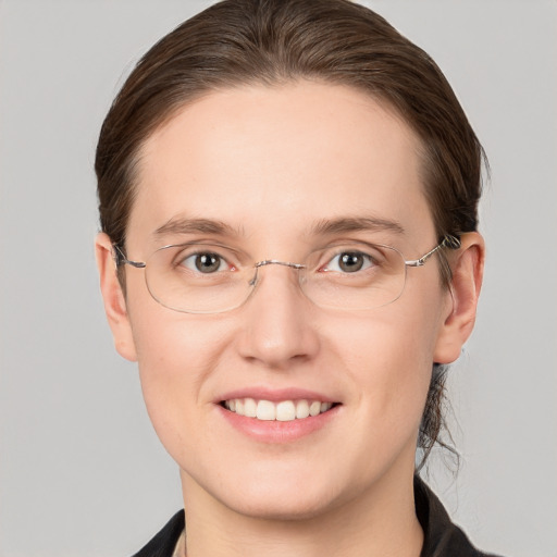 Joyful white young-adult female with short  brown hair and grey eyes