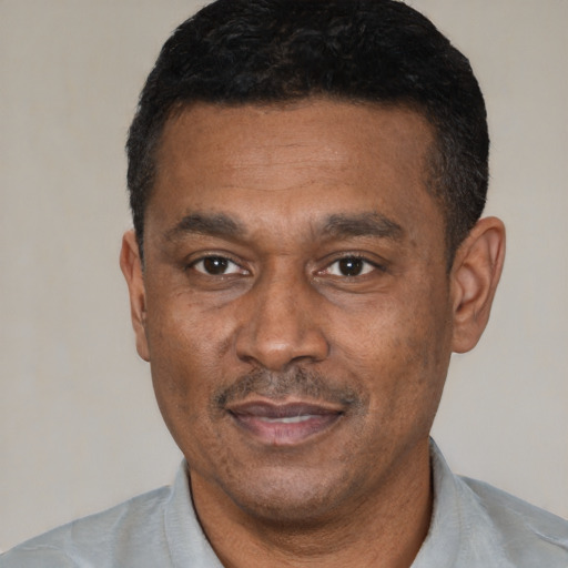 Joyful latino adult male with short  black hair and brown eyes