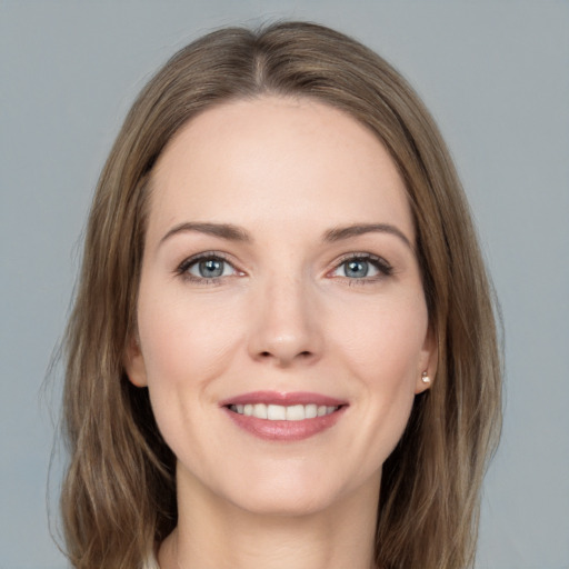 Joyful white young-adult female with medium  brown hair and grey eyes