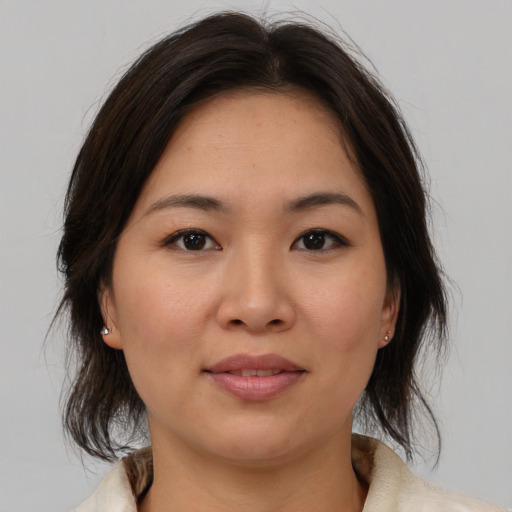 Joyful asian young-adult female with medium  brown hair and brown eyes