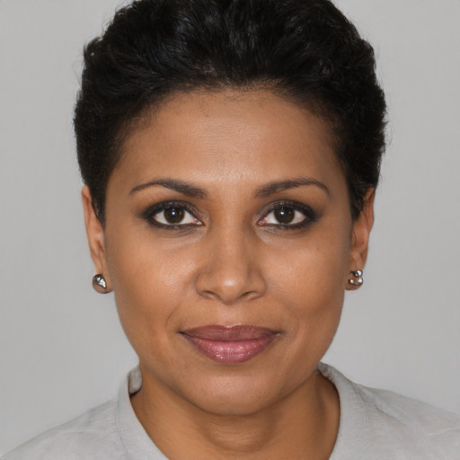 Joyful black young-adult female with short  brown hair and brown eyes