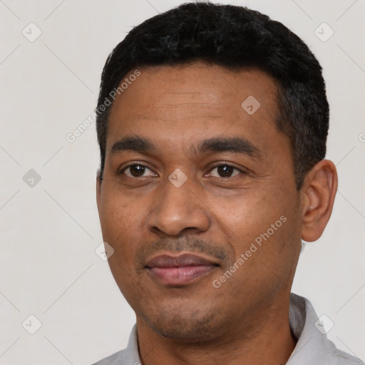 Joyful latino young-adult male with short  black hair and brown eyes