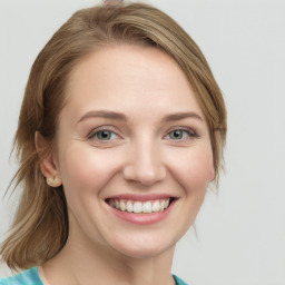 Joyful white young-adult female with long  brown hair and blue eyes