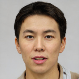 Joyful asian young-adult male with short  brown hair and brown eyes