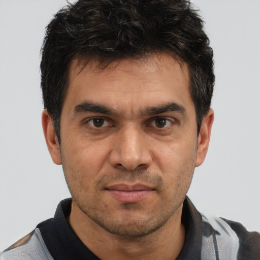 Joyful white adult male with short  brown hair and brown eyes