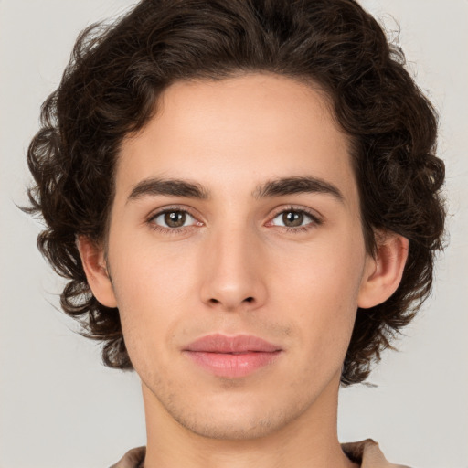 Joyful white young-adult male with medium  brown hair and brown eyes