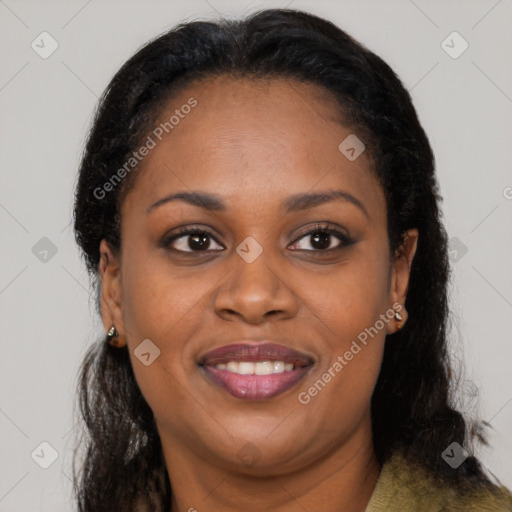 Joyful black young-adult female with long  brown hair and brown eyes