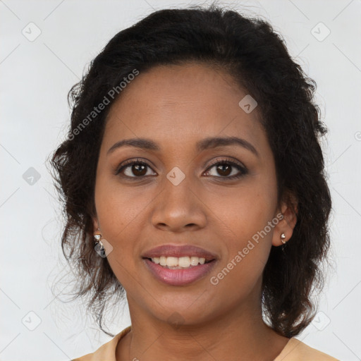 Joyful black young-adult female with long  brown hair and brown eyes