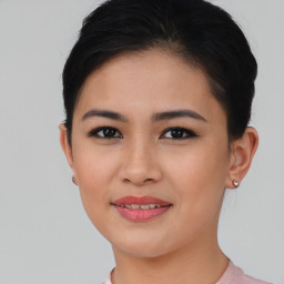 Joyful asian young-adult female with short  brown hair and brown eyes