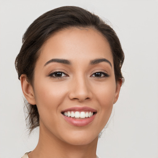 Joyful white young-adult female with medium  brown hair and brown eyes