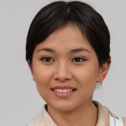 Joyful asian young-adult female with short  brown hair and brown eyes