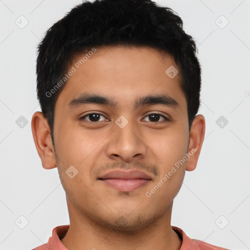 Joyful latino young-adult male with short  brown hair and brown eyes