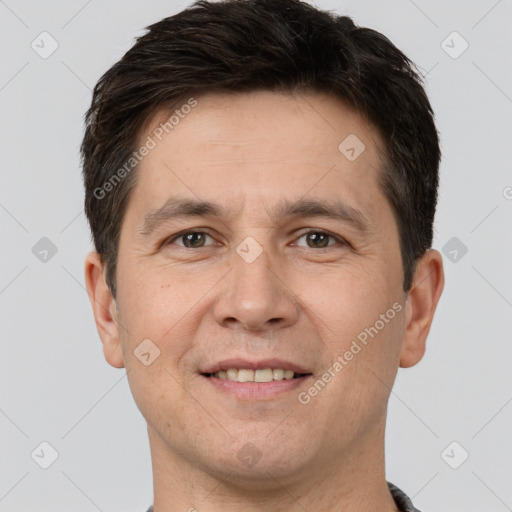 Joyful white adult male with short  brown hair and brown eyes