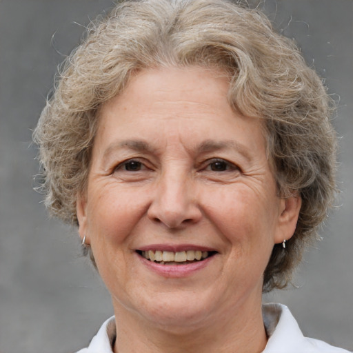 Joyful white middle-aged female with medium  brown hair and brown eyes