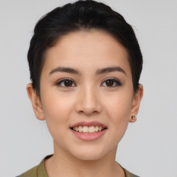 Joyful asian young-adult female with short  brown hair and brown eyes