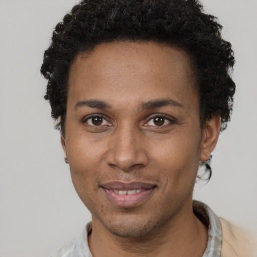 Joyful black adult female with short  brown hair and brown eyes