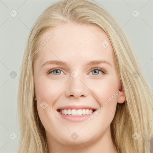 Joyful white young-adult female with long  brown hair and blue eyes