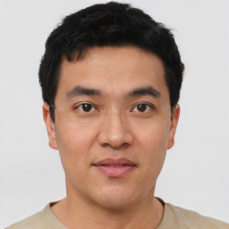 Joyful asian young-adult male with short  brown hair and brown eyes