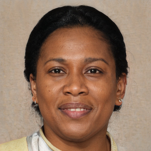Joyful black adult female with short  black hair and brown eyes