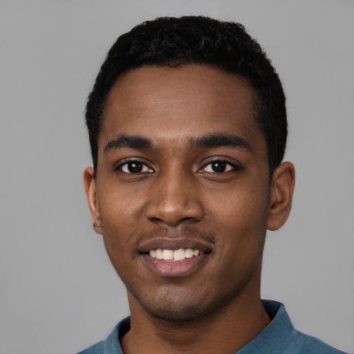 Joyful black young-adult male with short  black hair and brown eyes