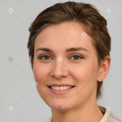 Joyful white young-adult female with medium  brown hair and green eyes