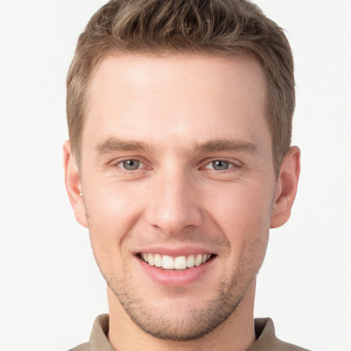 Joyful white young-adult male with short  brown hair and grey eyes