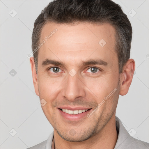 Joyful white adult male with short  brown hair and brown eyes