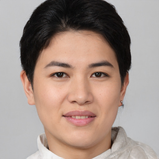 Joyful asian young-adult female with short  brown hair and brown eyes