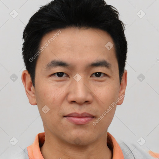 Joyful asian young-adult male with short  black hair and brown eyes