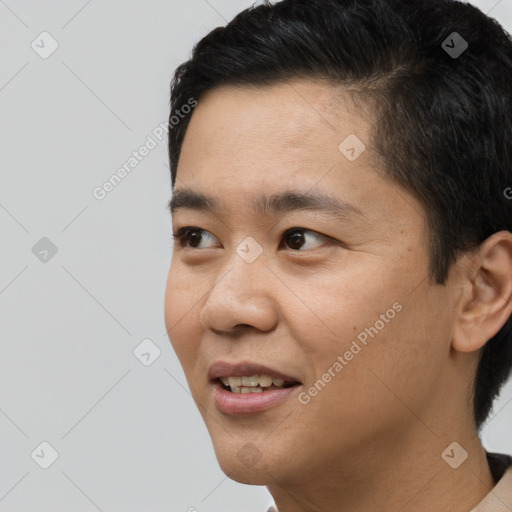 Joyful asian young-adult male with short  black hair and brown eyes