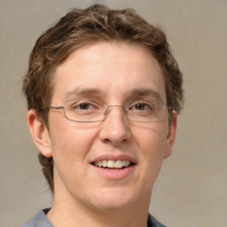 Joyful white adult male with short  brown hair and grey eyes