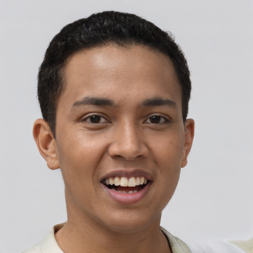 Joyful latino young-adult male with short  black hair and brown eyes