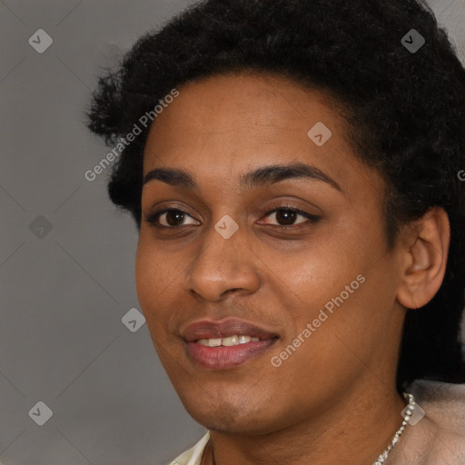 Joyful black young-adult female with short  black hair and brown eyes