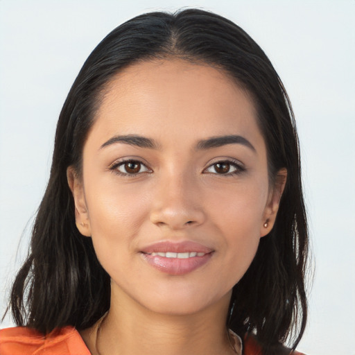 Joyful latino young-adult female with long  brown hair and brown eyes