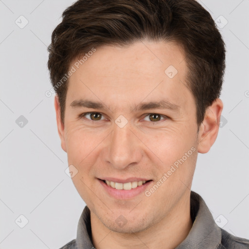 Joyful white adult male with short  brown hair and grey eyes