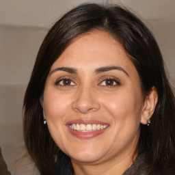 Joyful white adult female with medium  brown hair and brown eyes