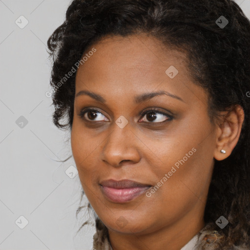 Joyful black young-adult female with long  brown hair and brown eyes