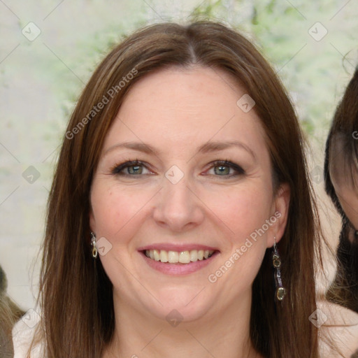 Joyful white adult female with long  brown hair and green eyes