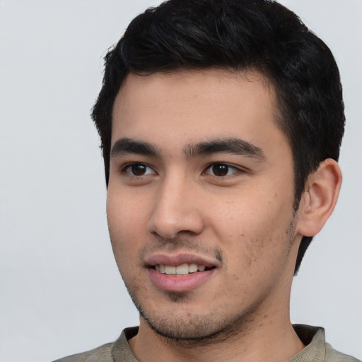 Joyful latino young-adult male with short  black hair and brown eyes