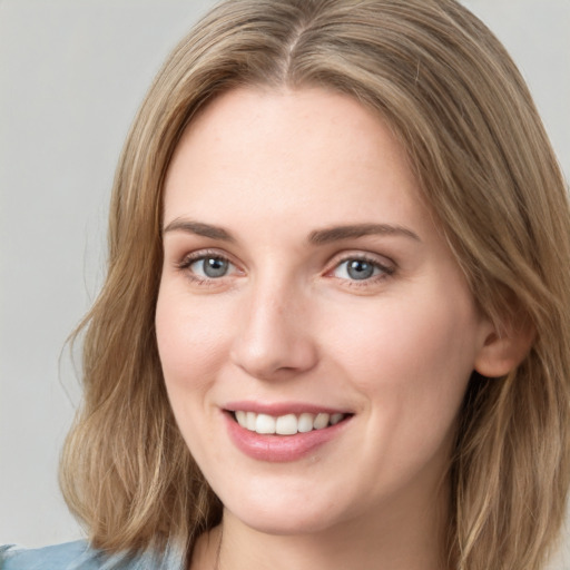 Joyful white young-adult female with medium  brown hair and green eyes