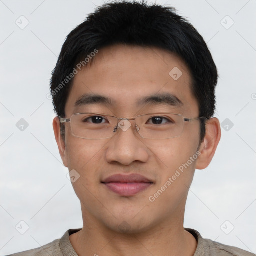 Joyful asian young-adult male with short  black hair and brown eyes