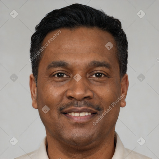Joyful latino adult male with short  black hair and brown eyes