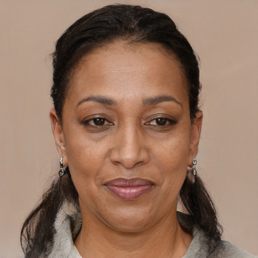 Joyful black adult female with medium  brown hair and brown eyes