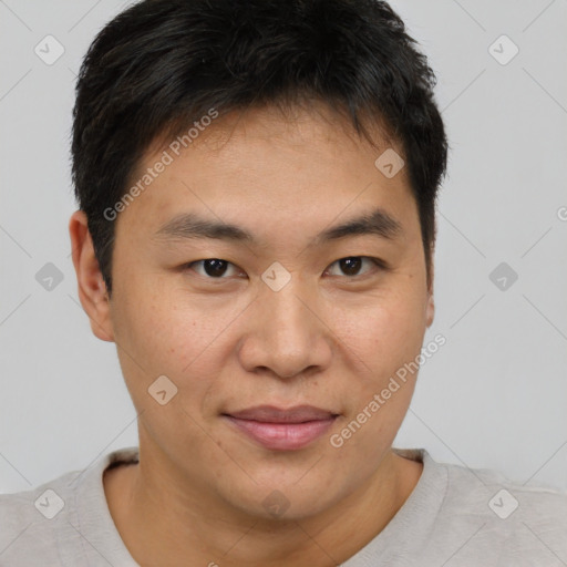 Joyful asian young-adult male with short  brown hair and brown eyes