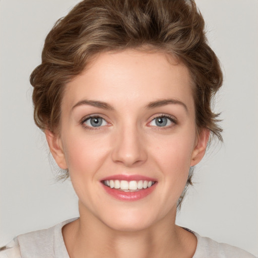 Joyful white young-adult female with medium  brown hair and green eyes